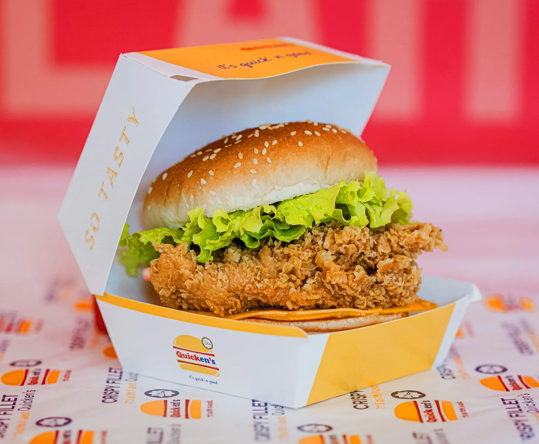 A crispy chicken fillet burger in an open Quicken’s box